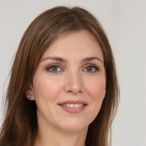 Joyful white young-adult female with long  brown hair and grey eyes