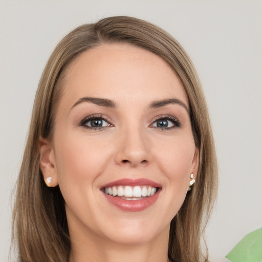 Joyful white young-adult female with long  brown hair and grey eyes