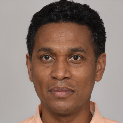 Joyful latino adult male with short  black hair and brown eyes
