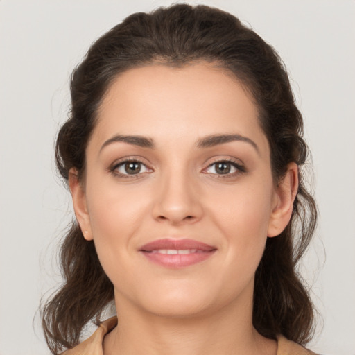 Joyful white young-adult female with medium  brown hair and brown eyes