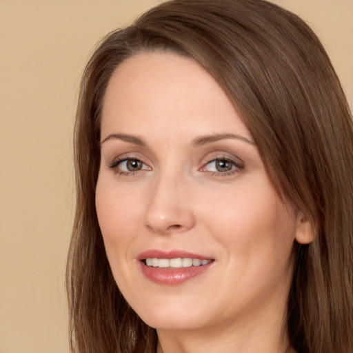 Joyful white adult female with long  brown hair and brown eyes