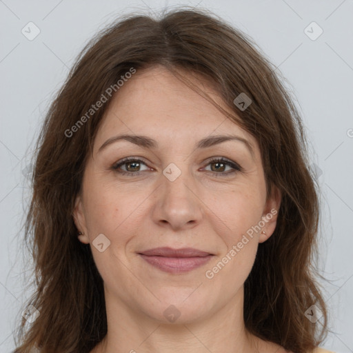 Joyful white adult female with long  brown hair and brown eyes