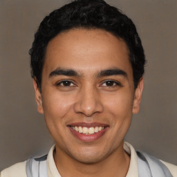 Joyful latino young-adult male with short  black hair and brown eyes