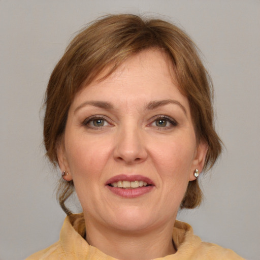 Joyful white adult female with medium  brown hair and brown eyes