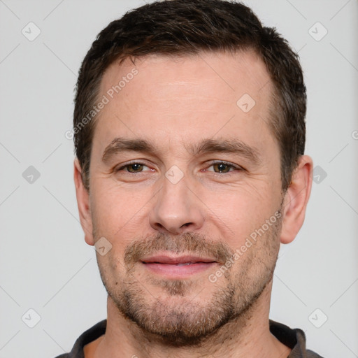 Joyful white adult male with short  brown hair and brown eyes