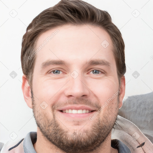 Joyful white young-adult male with short  brown hair and grey eyes