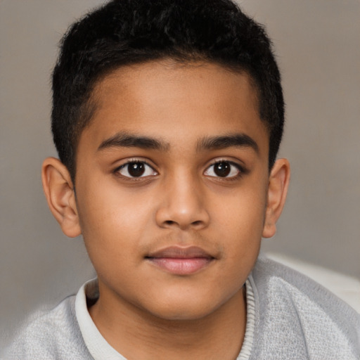 Joyful latino child male with short  brown hair and brown eyes