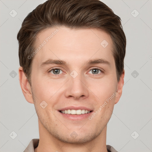 Joyful white young-adult male with short  brown hair and grey eyes