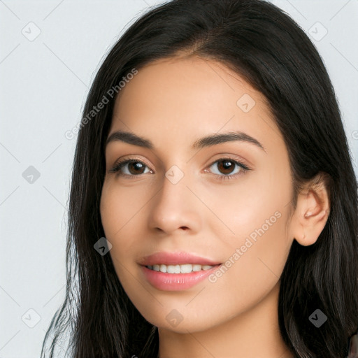 Joyful latino young-adult female with long  brown hair and brown eyes