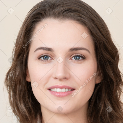 Joyful white young-adult female with long  brown hair and green eyes