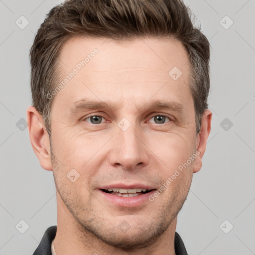 Joyful white adult male with short  brown hair and grey eyes