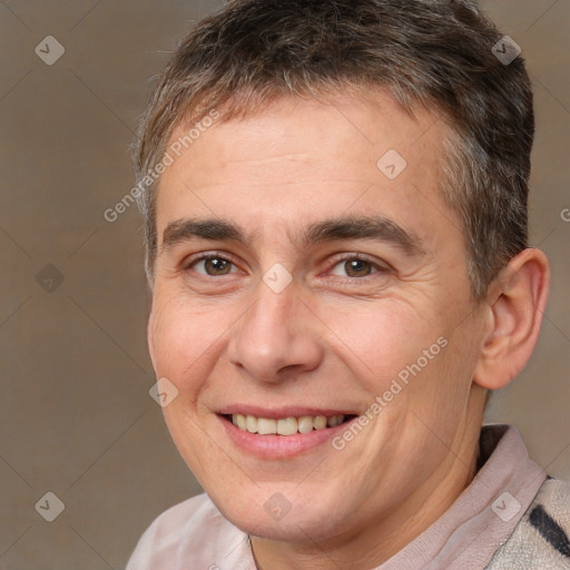 Joyful white adult male with short  brown hair and brown eyes