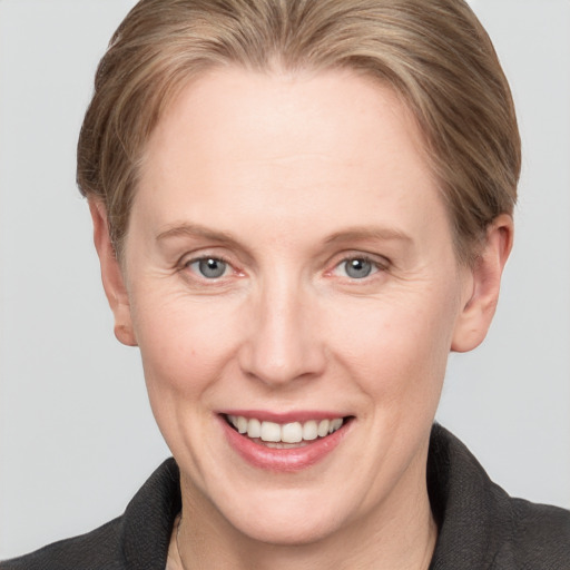 Joyful white adult female with short  brown hair and grey eyes