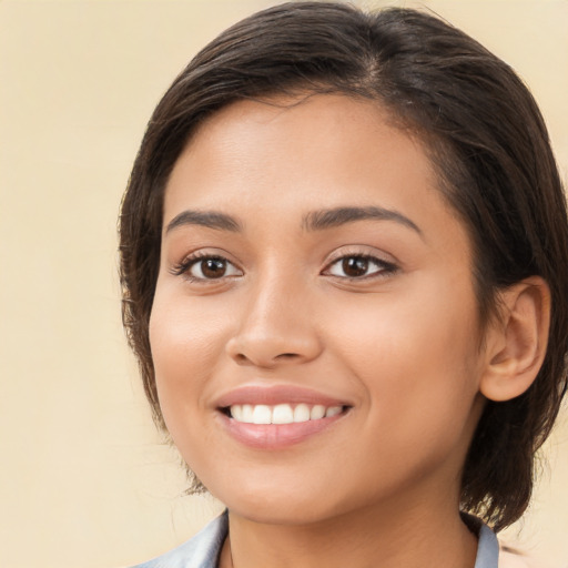 Joyful white young-adult female with medium  brown hair and brown eyes