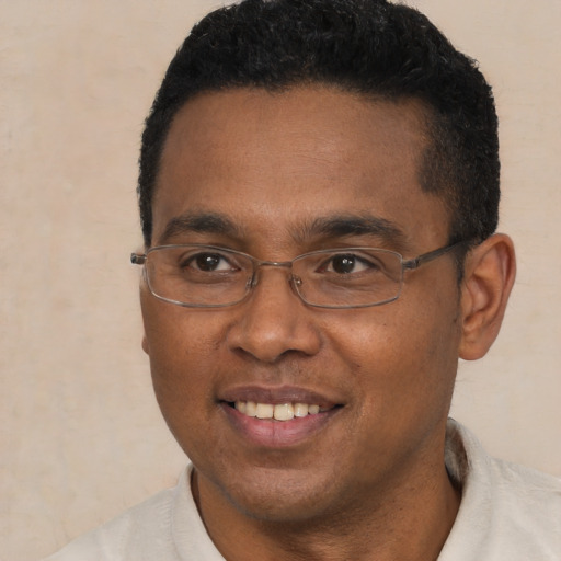 Joyful black young-adult male with short  black hair and brown eyes