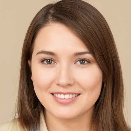 Joyful white young-adult female with long  brown hair and brown eyes