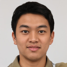 Joyful asian young-adult male with short  black hair and brown eyes