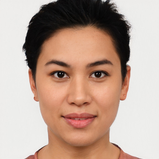 Joyful latino young-adult female with short  black hair and brown eyes