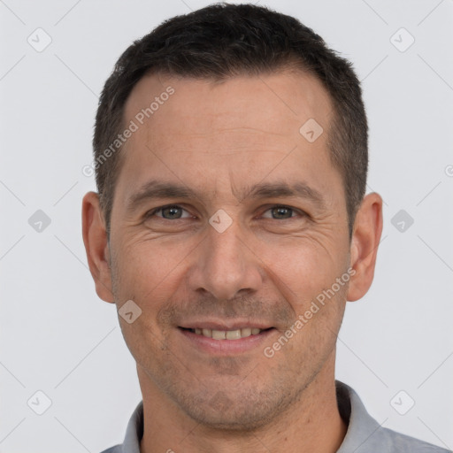 Joyful white adult male with short  brown hair and brown eyes