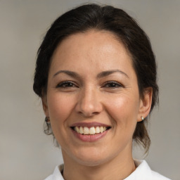 Joyful white adult female with medium  brown hair and brown eyes