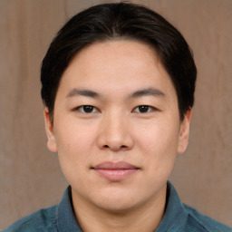 Joyful asian young-adult male with short  brown hair and brown eyes