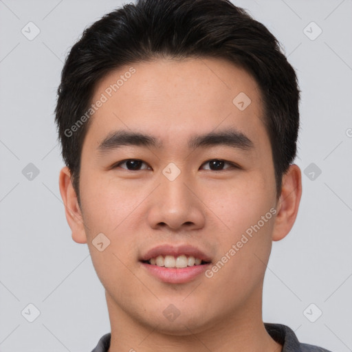 Joyful asian young-adult male with short  brown hair and brown eyes