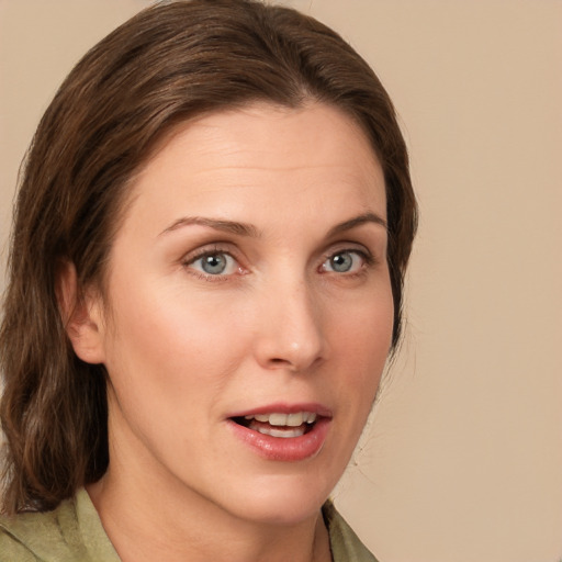 Joyful white young-adult female with medium  brown hair and grey eyes