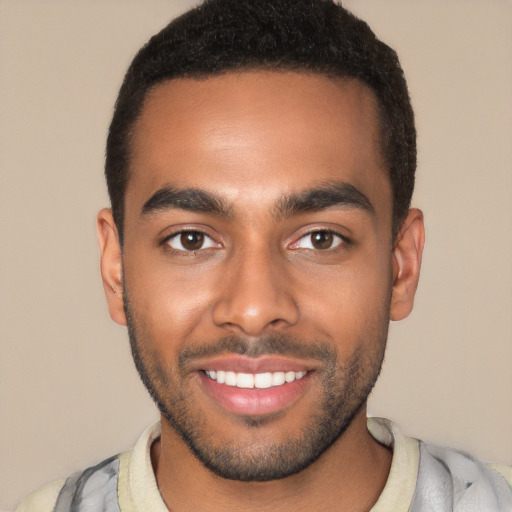 Joyful white young-adult male with short  black hair and brown eyes