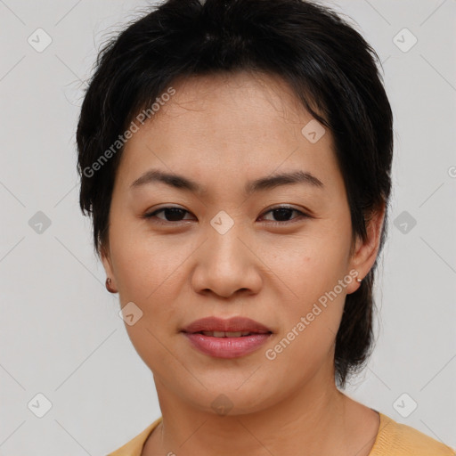 Joyful asian young-adult female with short  brown hair and brown eyes