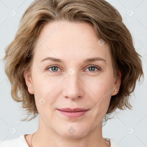 Joyful white young-adult female with medium  brown hair and blue eyes