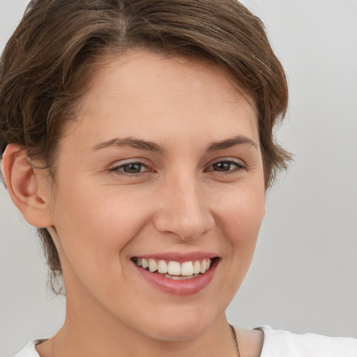 Joyful white young-adult female with short  brown hair and brown eyes