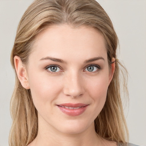 Joyful white young-adult female with long  brown hair and blue eyes