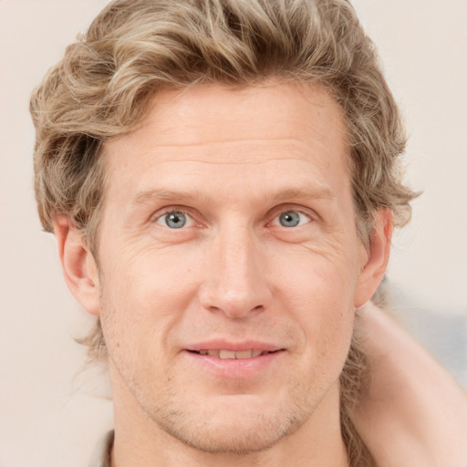 Joyful white adult male with short  brown hair and grey eyes