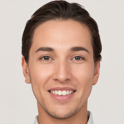 Joyful white young-adult male with short  brown hair and brown eyes