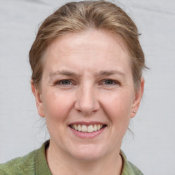 Joyful white adult female with short  brown hair and grey eyes