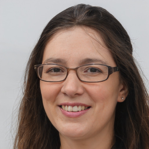 Joyful white adult female with long  brown hair and grey eyes