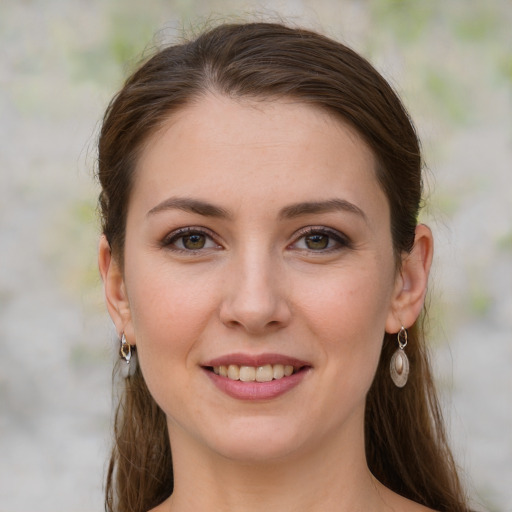 Joyful white young-adult female with long  brown hair and green eyes