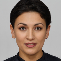 Joyful latino young-adult female with short  brown hair and brown eyes
