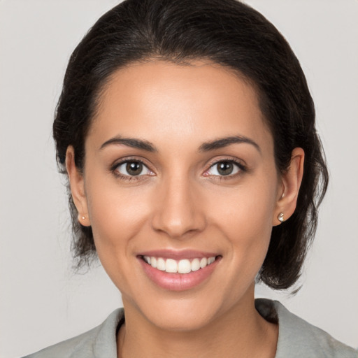 Joyful white young-adult female with medium  brown hair and brown eyes