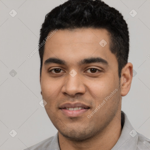 Joyful latino young-adult male with short  black hair and brown eyes