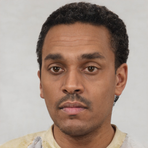 Neutral latino adult male with short  black hair and brown eyes