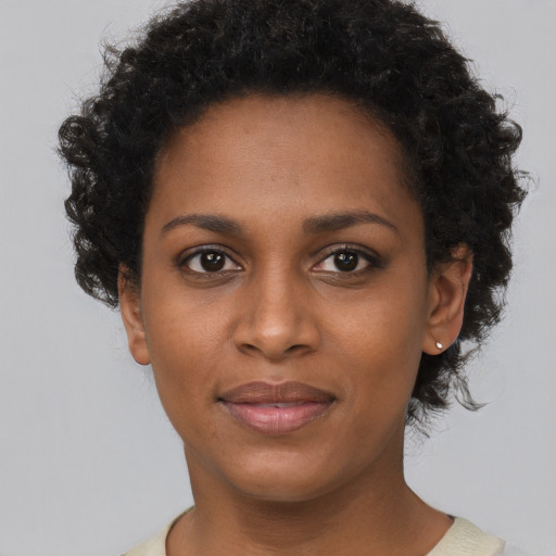 Joyful black young-adult female with short  brown hair and brown eyes