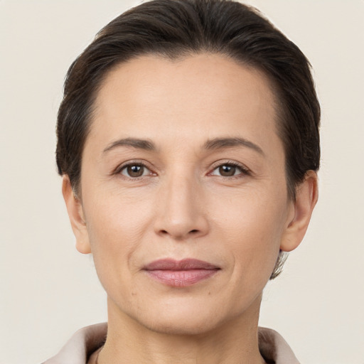 Joyful white adult female with short  brown hair and brown eyes