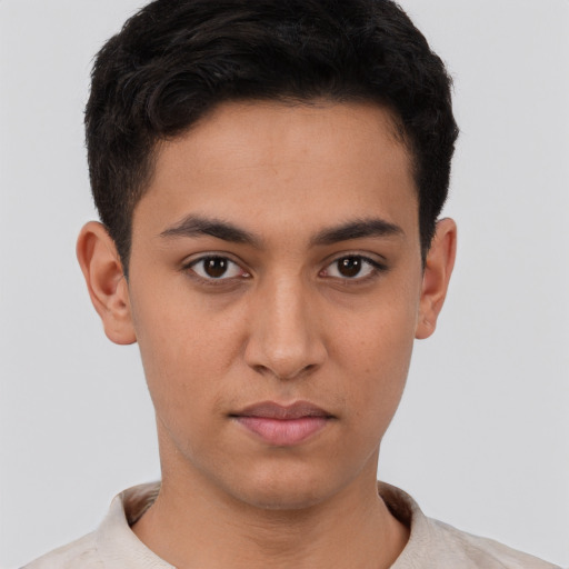 Joyful latino young-adult male with short  brown hair and brown eyes