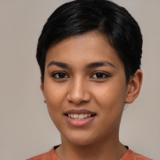 Joyful latino young-adult female with short  brown hair and brown eyes