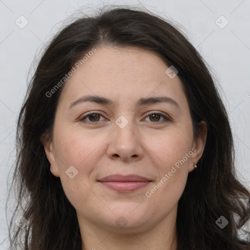 Joyful white adult female with long  brown hair and brown eyes