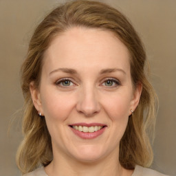 Joyful white young-adult female with medium  brown hair and green eyes