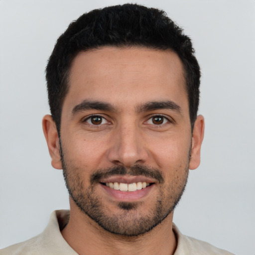 Joyful white young-adult male with short  black hair and brown eyes