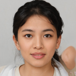 Joyful asian young-adult female with medium  black hair and brown eyes