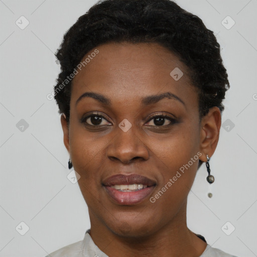 Joyful black young-adult female with short  black hair and brown eyes